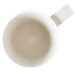 A close-up of a white Carlisle Tritan mug with a handle.