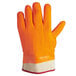 An orange San Jamar freezer glove with a white palm.