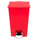 A red Rubbermaid rectangular plastic mobile step-on trash container with a lid and pedal.