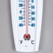 A Taylor wall thermometer showing the temperature in red and blue.