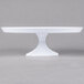 A Fineline white cake stand with a white pedestal base.