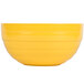 A yellow Vollrath beehive serving bowl.