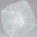 A close-up of a Berry low density clear plastic trash bag.