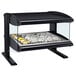 A black Hatco countertop food warmer with a glass top and food on a shelf.