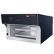 A black and silver Hatco Flav-R-Savor pass-through heated air curtain on a counter with two trays inside.