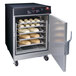 A Hatco Flav-R-Savor holding cabinet with trays of bread inside.