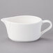 A Tuxton white china gravy boat with a handle.