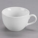 A close-up of a Tuxton Modena AlumaTux Pearl White cup with a handle.
