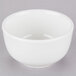 A Tuxton Modena AlumaTux Pearl White China sugar or bouillon bowl with a small rim on a gray surface.