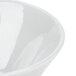 A close-up of a Tuxton TuxTrendz Linx white china bowl with a white rim.