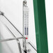 A thermometer on a Hunter Green metal shelf inside a Hatco Glo-Ray countertop food warmer.