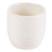 A white porcelain sake cup with a white background and a white rim.