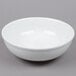 A Tuxton porcelain white china serving bowl on a gray surface.