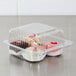 A Dart clear hinged PET plastic container with a variety of pastries.