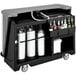 A black Cambro portable bar cart with bottles on it.
