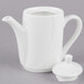 A white Tuxton ceramic coffee pot with a lid.