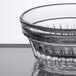 A close-up of a Libbey Winchester clear glass ramekin with a pattern on it.