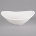 A Tuxton AlumaTux white bowl with a curved edge.