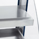 A close up of a navy blue and silver metal shelf in a Hatco countertop warmer.