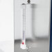A thermometer on a metal Hatco countertop warmer shelf.