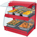 A red Hatco countertop double shelf food warmer with trays of food on display.