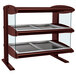 A Hatco heated zone merchandiser with double shelves holding trays in a bakery display case.