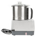 A Robot Coupe commercial food processor with a silver base.
