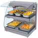 A Hatco countertop display case with food on double shelves.