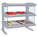 A Hatco heated zone merchandiser with food on double shelves.