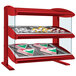 A red Hatco countertop display case with food on slanted shelves.