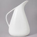 A white 10 Strawberry Street Whittier milk pitcher with a handle.