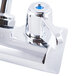 A chrome Equip by T&S wall mounted faucet with blue lever handles.