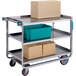 A Lakeside stainless steel 3 shelf utility cart with boxes on it.