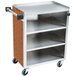 A stainless steel utility cart with a wood grained surface.