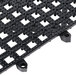 A black plastic San Jamar Versa-Mat grid with holes.
