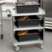 A Lakeside stainless steel utility cart with three shelves on it.