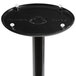 A black Lancaster Table & Seating cast iron bar height table base with white screws on it.