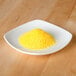 A small plate of yellow powder for rimming drinks.