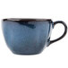 A close-up of a Tuxton Artisan Night Sky blue china cup with a handle.