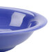 A close-up of a purple Thunder Group melamine soup bowl with a blue surface.