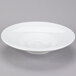 A white Tuxton Skye china bowl with a small rim on a gray surface.