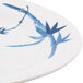 A white oval melamine platter with blue bamboo design.