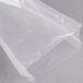 A clear plastic bag of ARY VacMaster Cook-In Chamber Re-Therm Vacuum Packaging Bags on a grey surface.