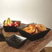 A group of American Metalcraft square birch bread baskets filled with bread and fruit on a table.