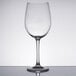A close-up of a Chef & Sommelier tall wine glass with a silver rim on a white surface.