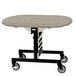 A Geneva room service table with beige suede top on a black metal frame with wheels.