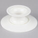 An American Metalcraft white porcelain serving stand with a round base on a white surface.