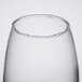 An Arcoroc Salto cooler glass with a small amount of liquid in it.