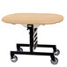 A Geneva round top room service table with a maple finish and wheels.