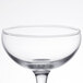An Arcoroc clear coupe glass with a stem.